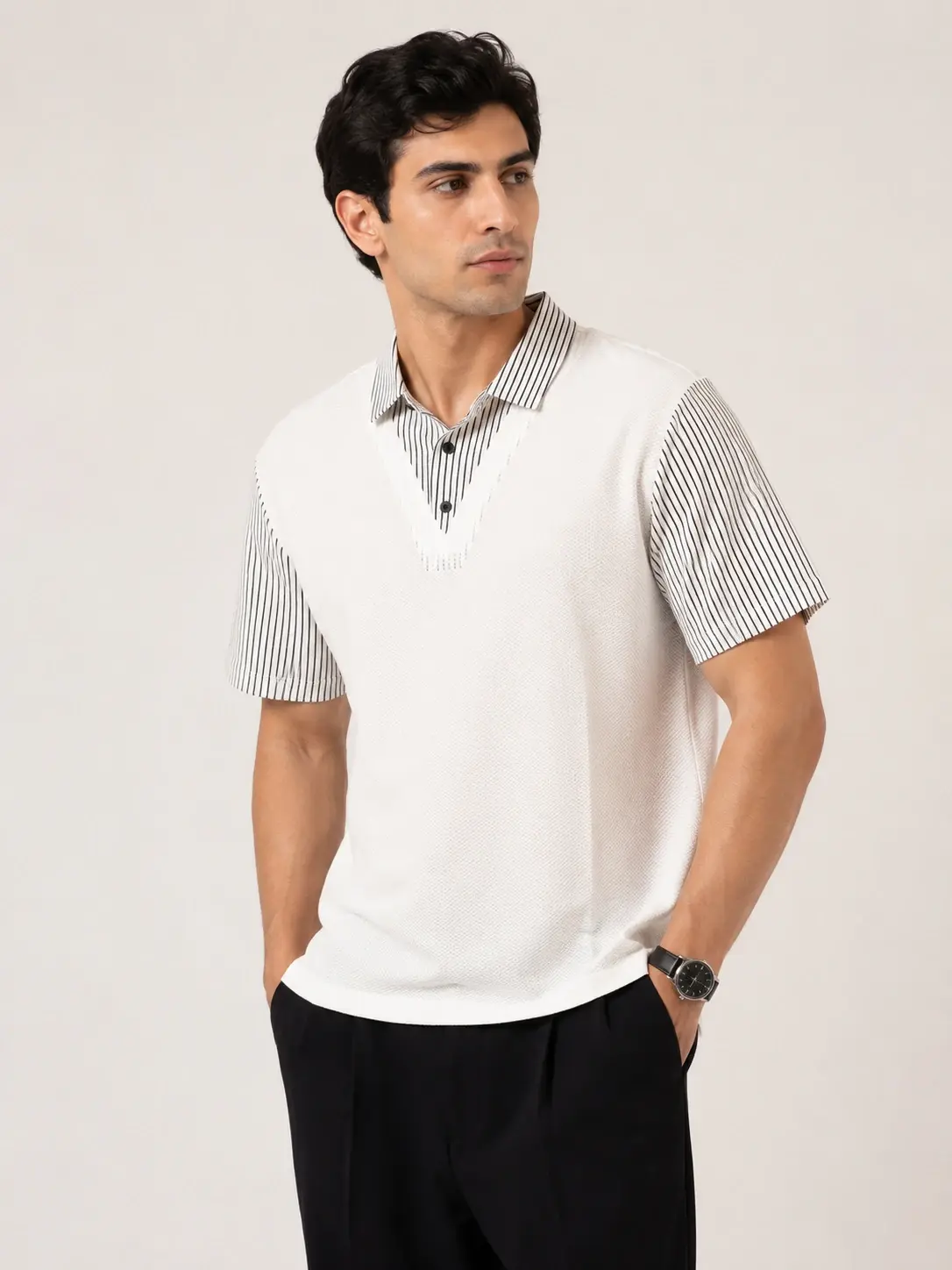 Model wearing a white knit polo with striped short sleeves